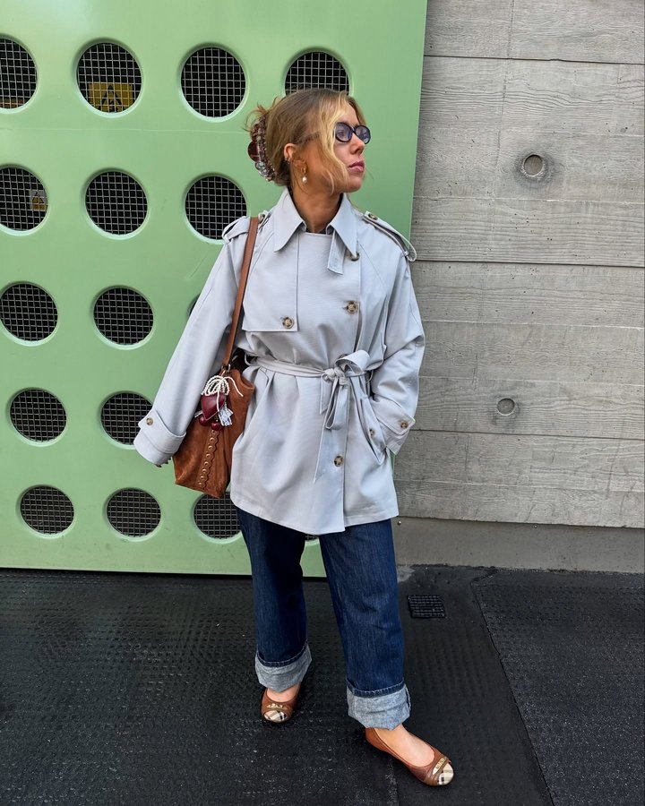 Instagram post by @jessjepson_ for Estella Bartlett. Caption reads: Trench coat buttoned up to the TOP!!....