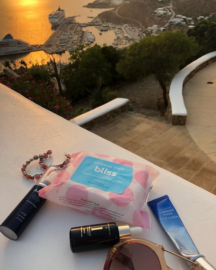 Instagram post by @lanzybear for Bliss World. Caption reads: Just me and my travel buddy @blissworld makeup....