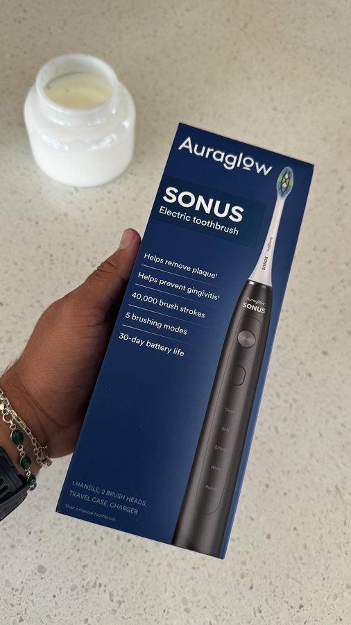 Instagram post by @cosmopolitips for AURAGLOW. Caption reads: [...] a solid toothbrush is a must. The @auraglow....