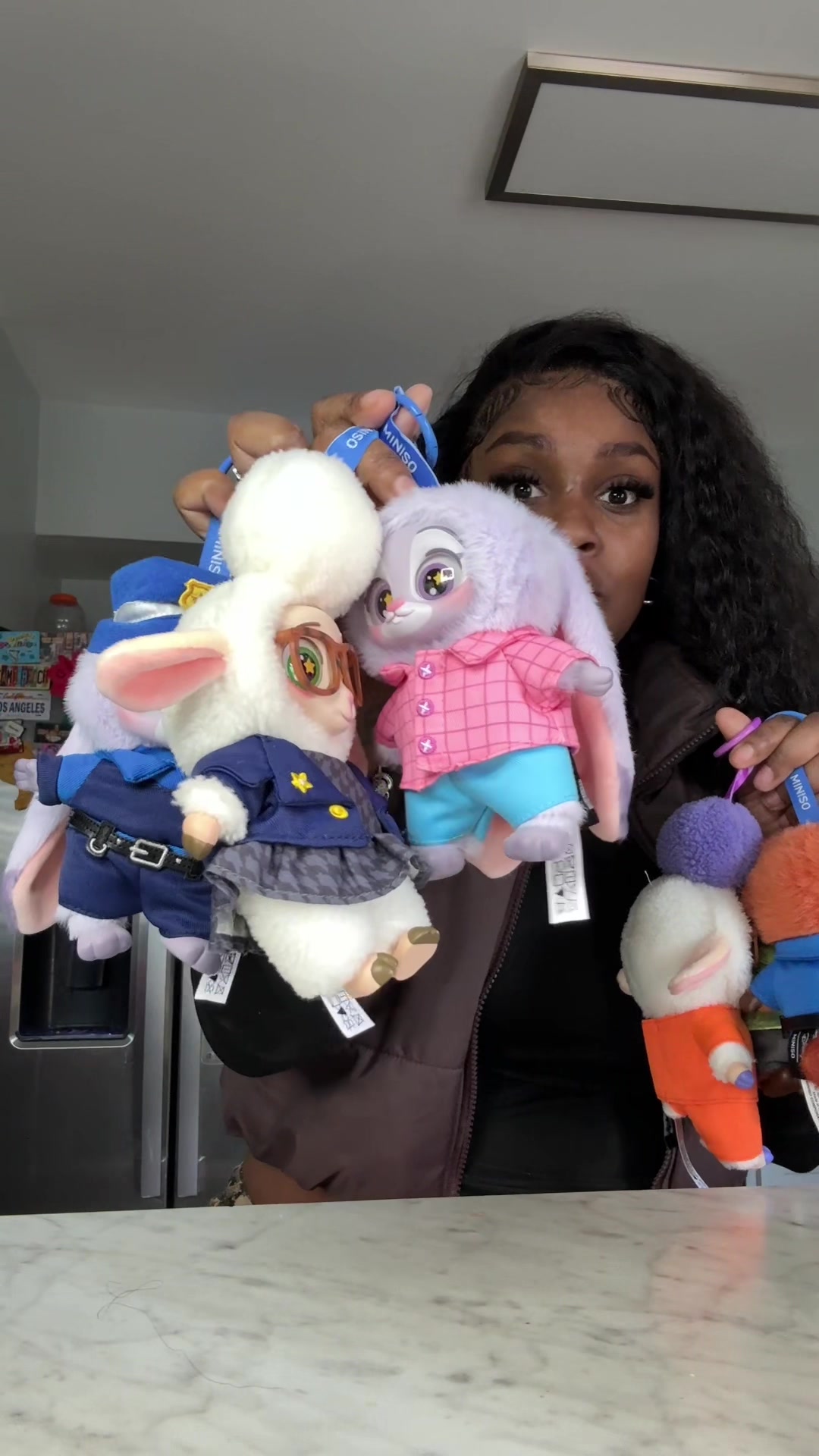 TikTok post by an influencer for MINISO. Caption reads: [...] plushies🥰🥰 #brownskinmami #minisopartner....