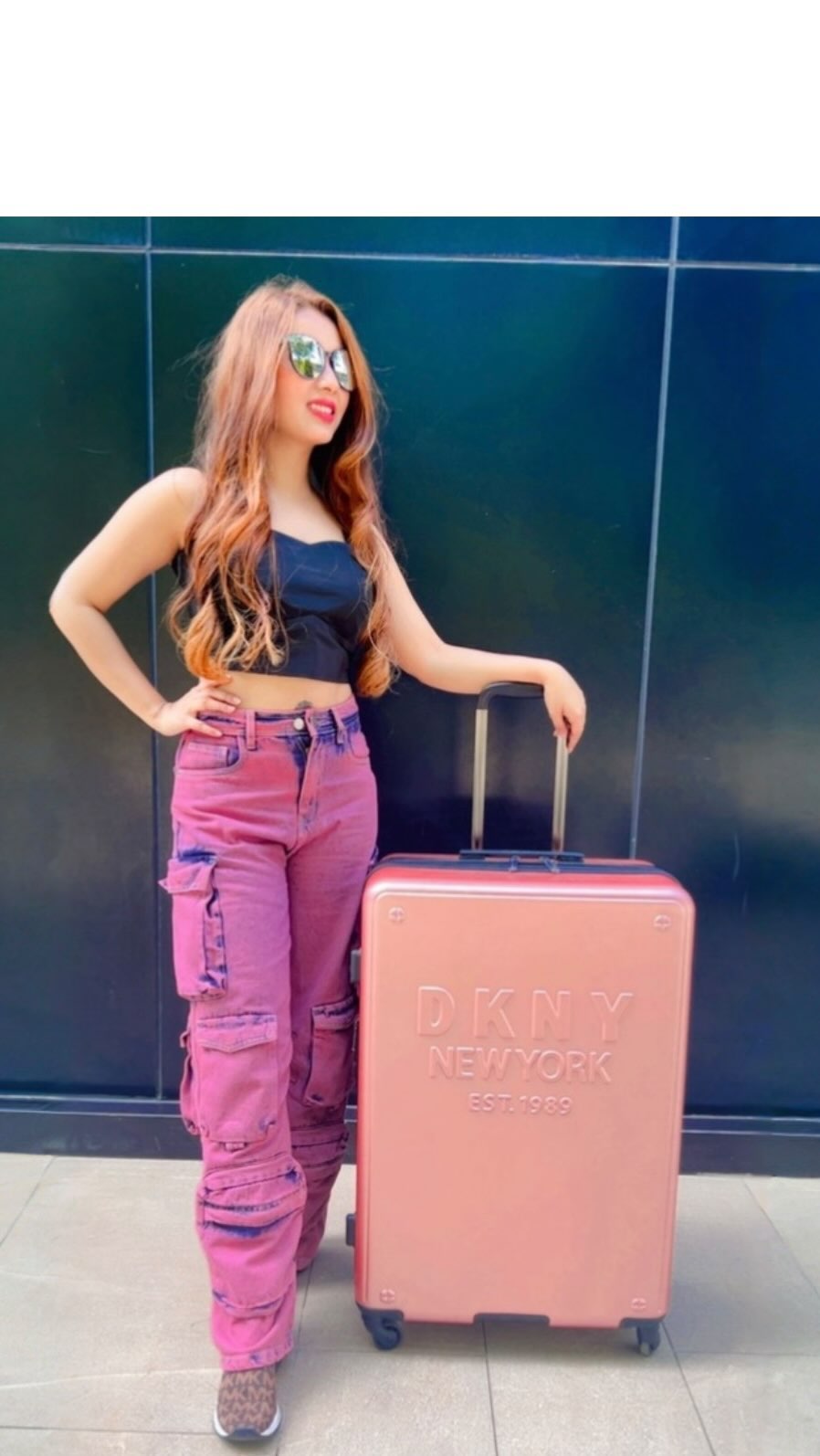 Instagram post by @samaira_bellasimo for DKNY. Caption reads: Life is better with a suitcase full of memories.....