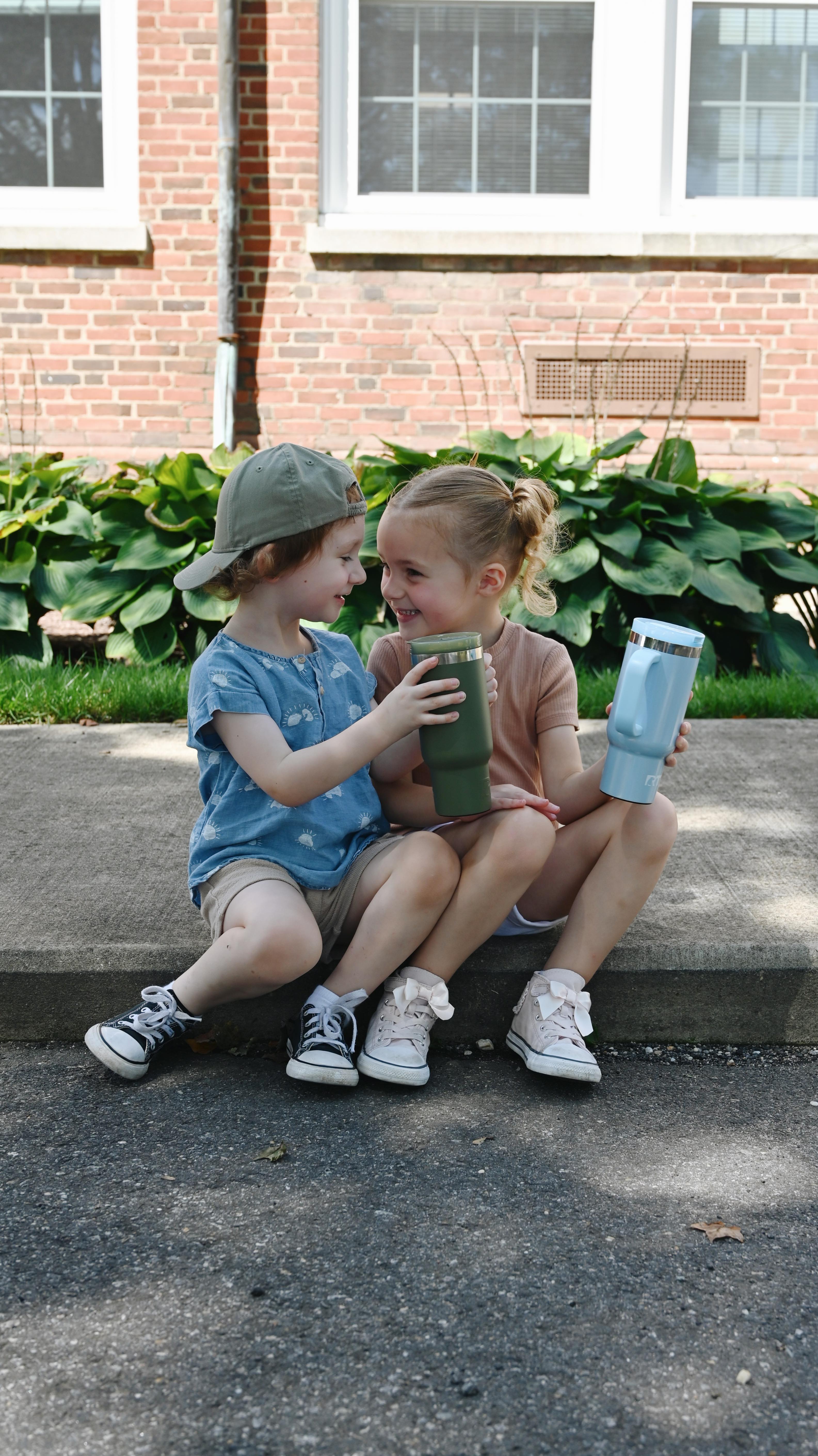 Instagram post by @emilywondree for Rtic Outdoors. Caption reads: Outdoor playdates = sunshine, snacks, and hydrated....