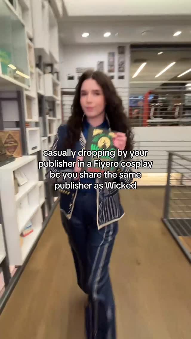 Instagram post by @caitsbooks for Epic Reads. Caption reads: dancing through life in the office 🙂‍↕️.