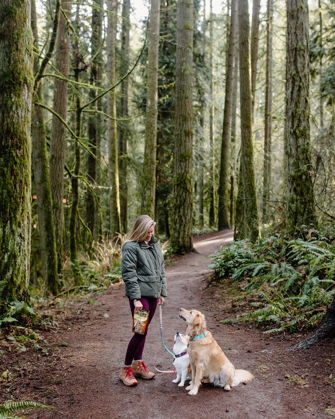 Instagram post by @littlepnwpups for Earthborn Holistic Pet Food. Caption reads: The green of the PNW is something else🌲

#ad To....