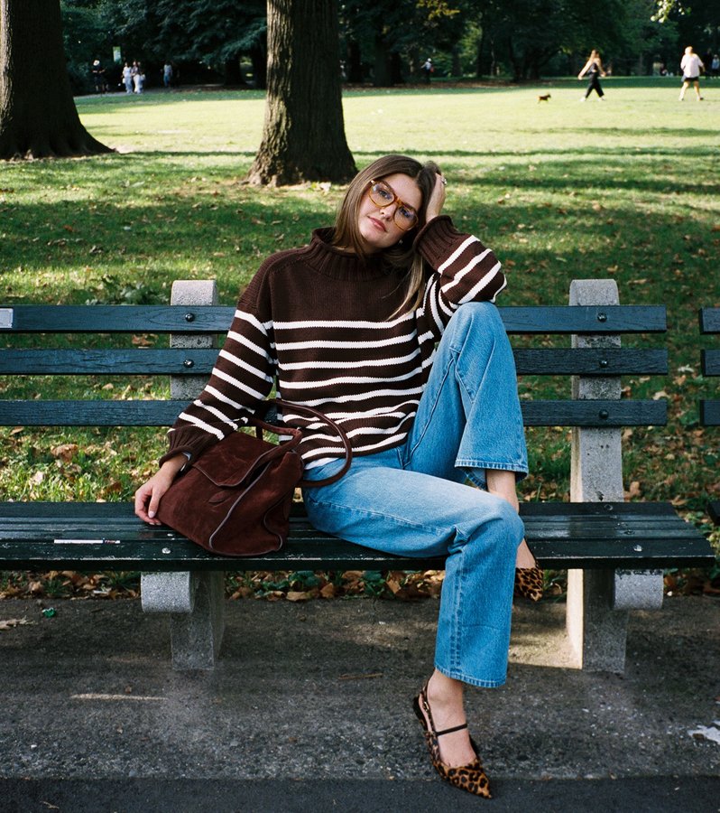 Instagram post by an influencer for J.Crew. Caption reads: life in @jcrew rollneck sweater 🥨🦮💛🌭.
