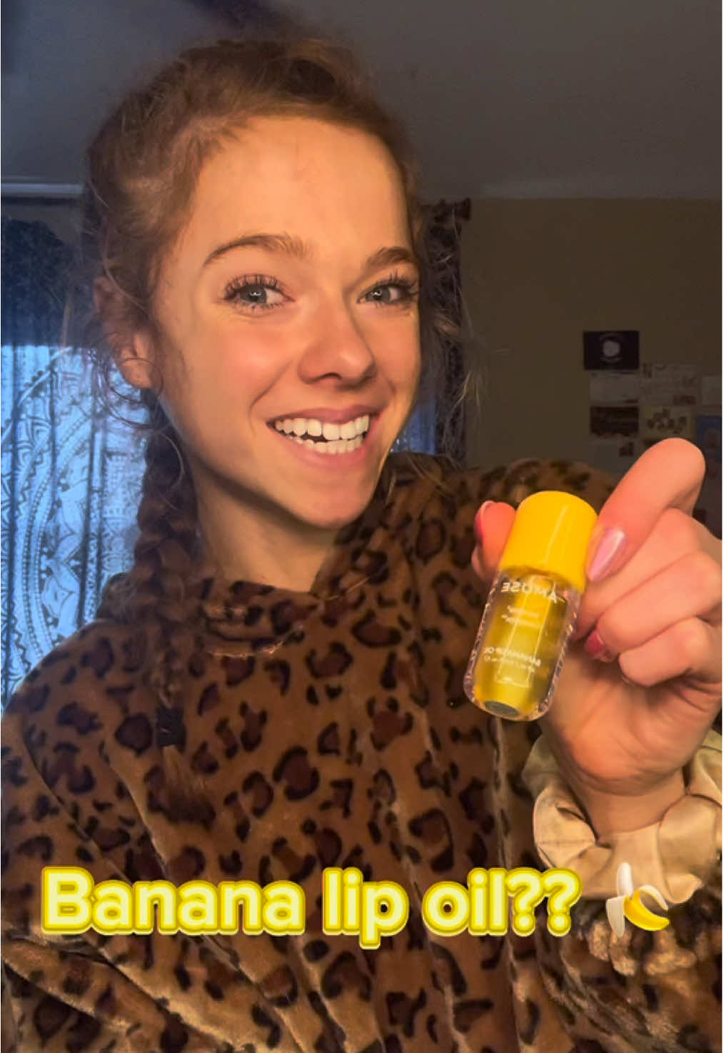 TikTok post by @sloaneunfiltered for AMUSE Seoul. Caption reads: [...] #bananalipoil #lipoil #lipcare @AMUSE Seoul.