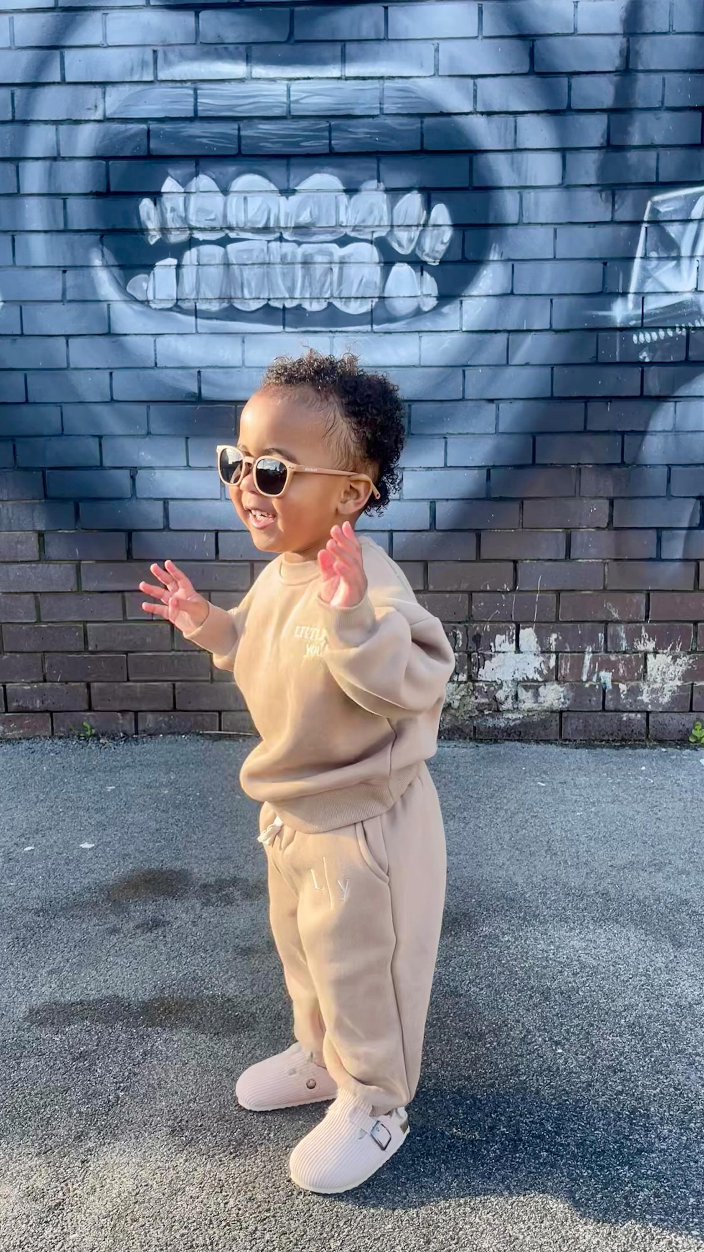 Instagram post by @metier.social for Polarised Baby Sunglasses. Caption reads: tiny trendsetter approved 😎 these....