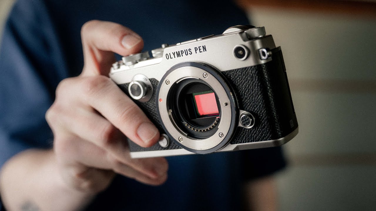 YouTube post by @GeorgeHolden for Moment. Caption reads: You Don't Need a Full Frame Camera for Street....