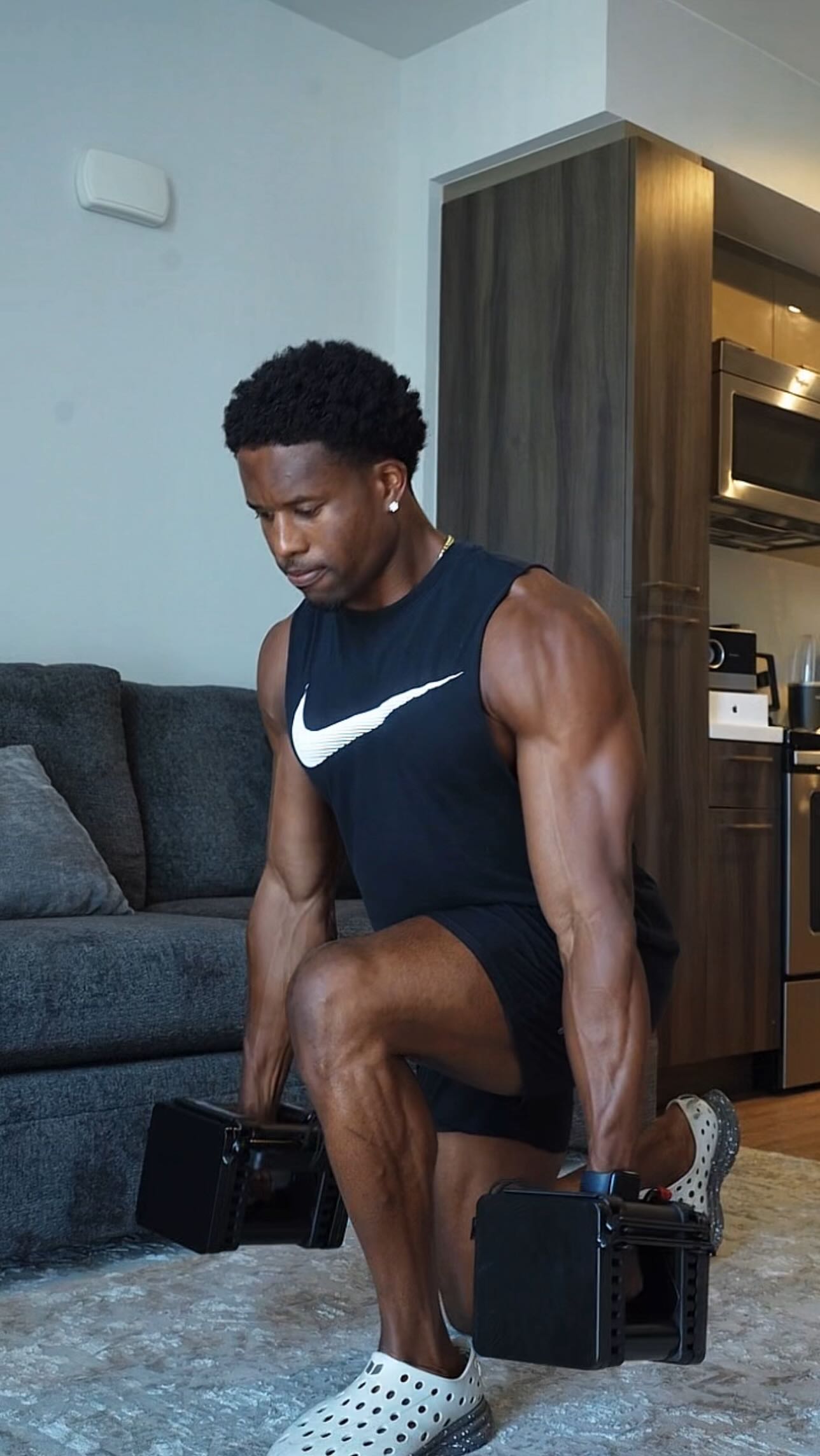 Instagram post by @trainwithseanharris for PowerBlock. Caption reads: PowerBlock Adjustable Dumbbells Perfect for your....