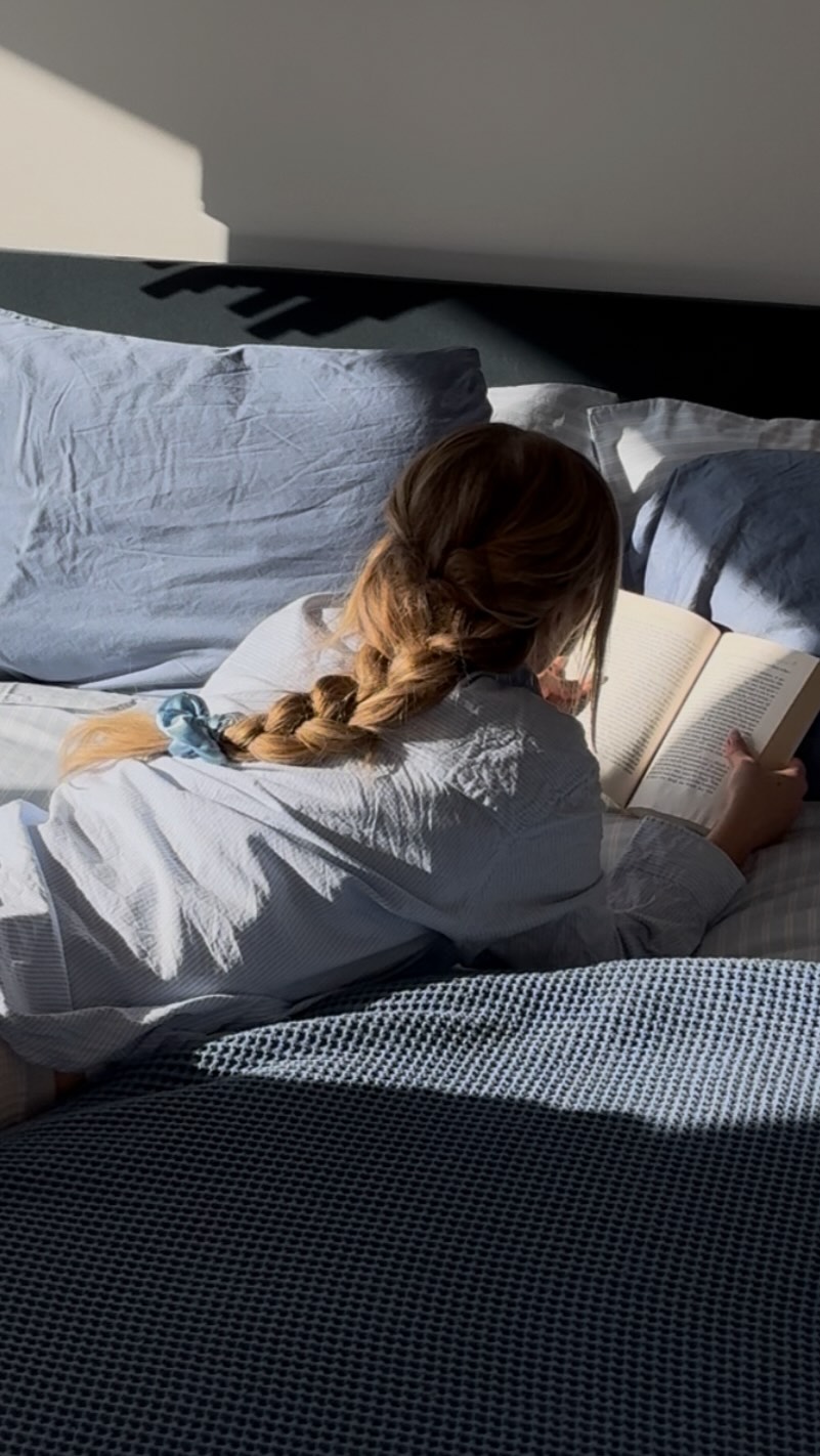 Instagram post by @laurenkyle1 for Brooklinen. Caption reads: No better feeling than my book and a new set of....