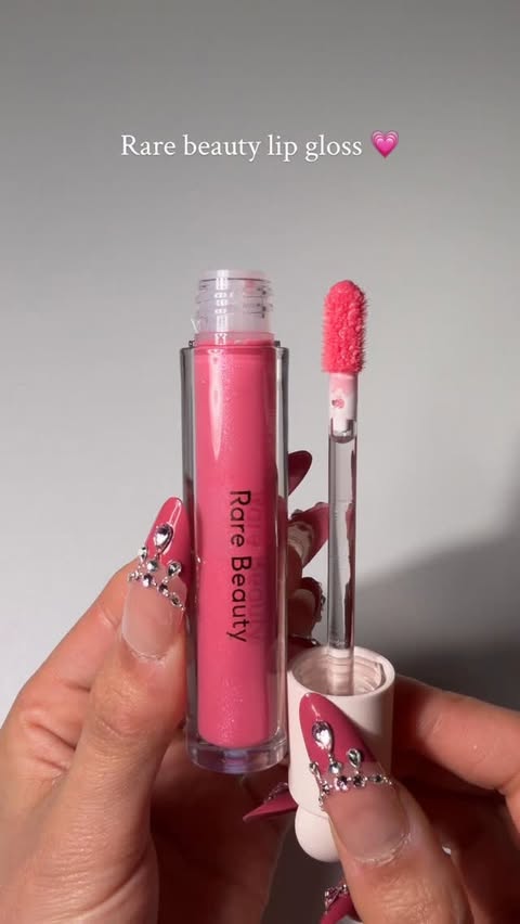 Instagram post by @sairasglam for Rare Beauty. Caption reads: Luminizing  lip gloss @rarebeauty 💖

I’ve been....