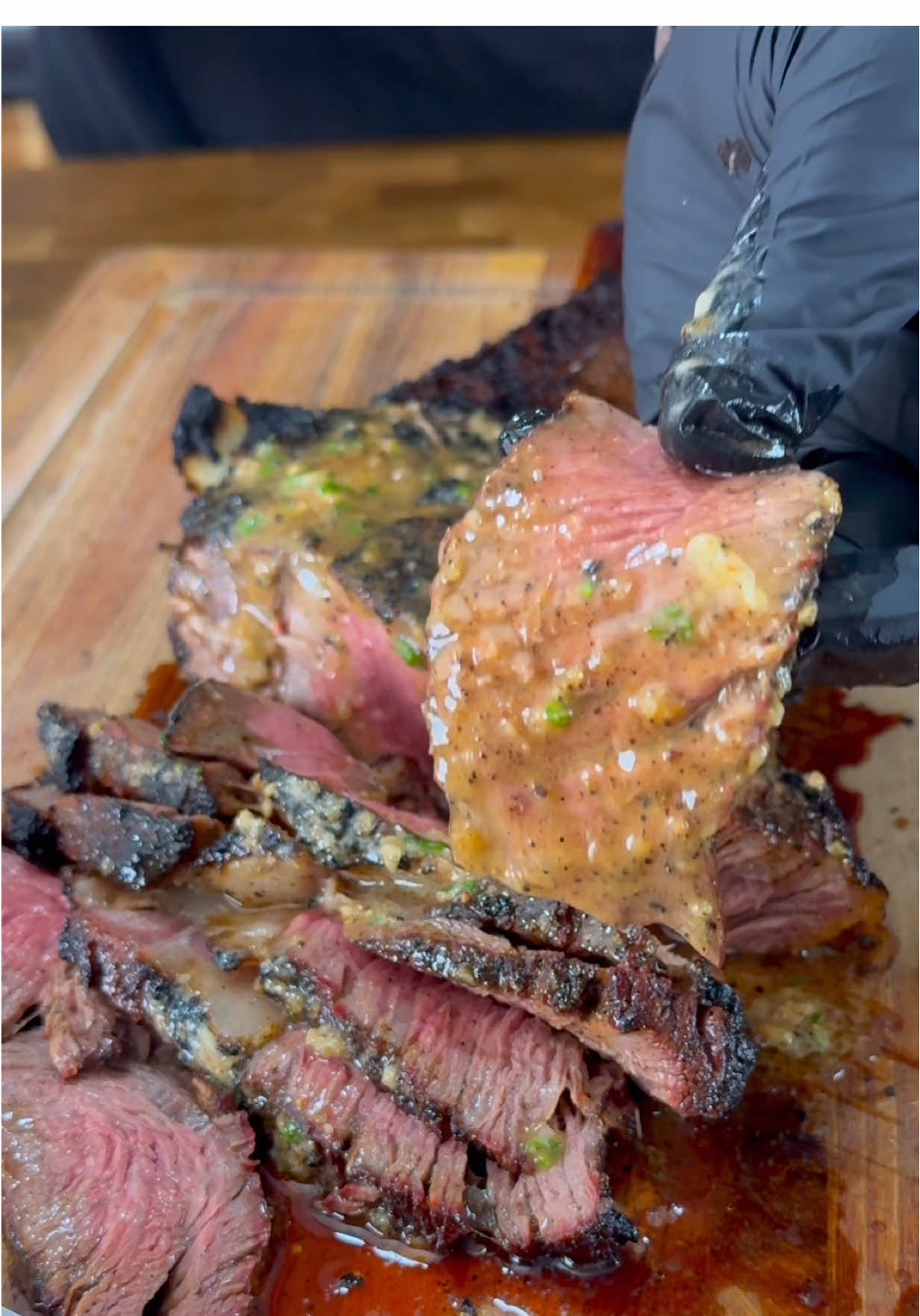 TikTok post by @cooking.with.cj for SNS Grills. Caption reads: [...] compound butter! 🔥🔥🔥 #steak #ribeye....