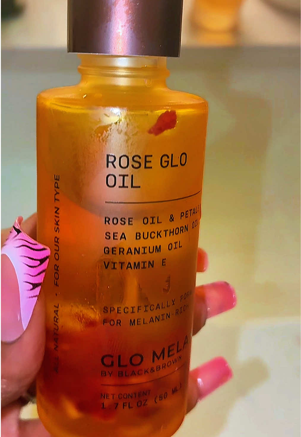 TikTok post by @scorpioexclusive for Glo Melanin. Caption reads: Rose Glo Oil 🌹 ✨10/10 @✨ Glo Melanin ✨ #rose #oil....