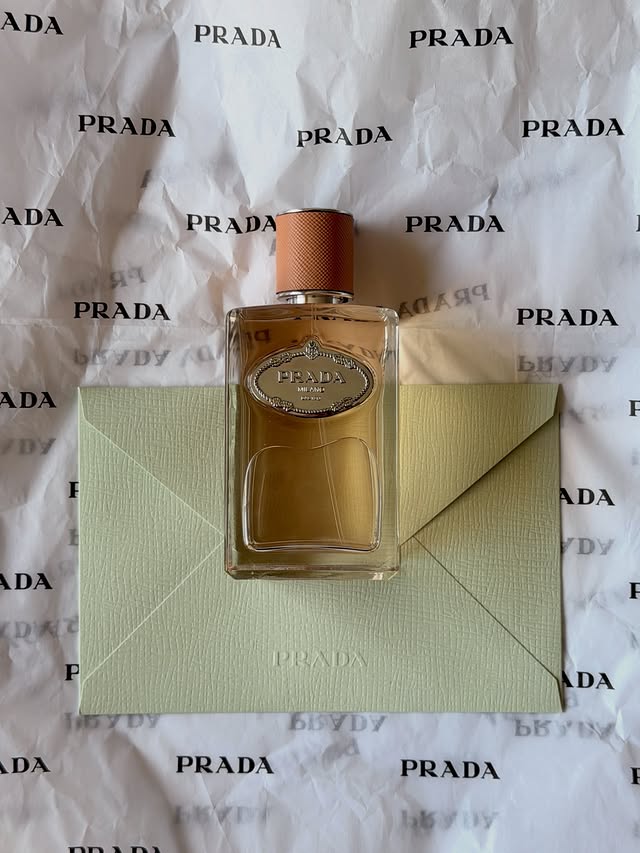 Instagram post by an influencer for Prada Beauty. Caption reads: [...] fragrances, but elevated 🤍 @pradabeauty....