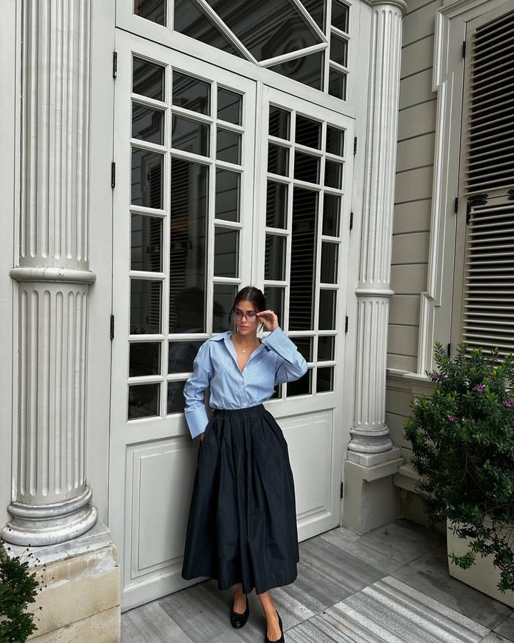 Instagram post by @aysunyildizgungor for adL. Caption reads: The combination of a long skirt and glasses....