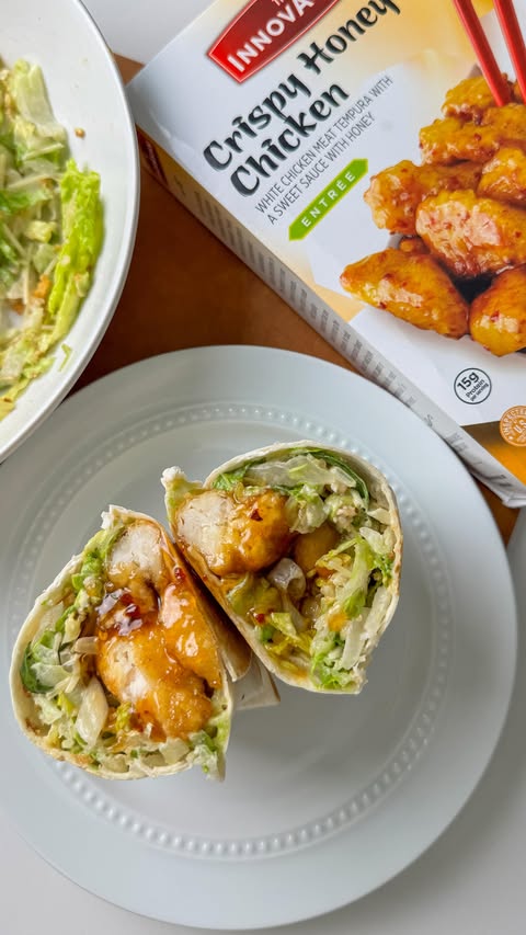 Instagram post by @happyandfull_ for InnovAsian Cuisine. Caption reads: CRISPY honey chicken Caesar wraps Next time you’re....