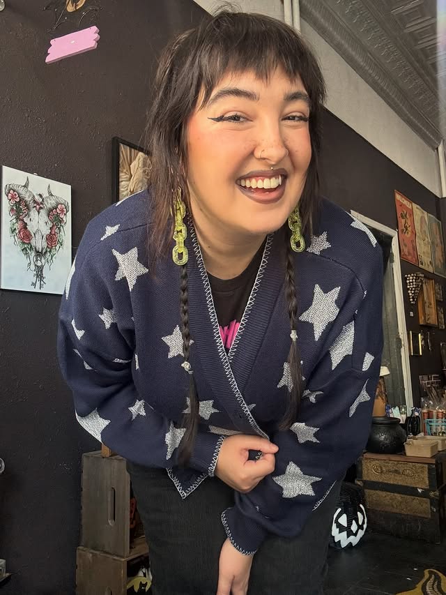 Instagram post by @briannakayhorror for Hot Topic. Caption reads: [...] loving this Coraline cardigan from @hottopic....