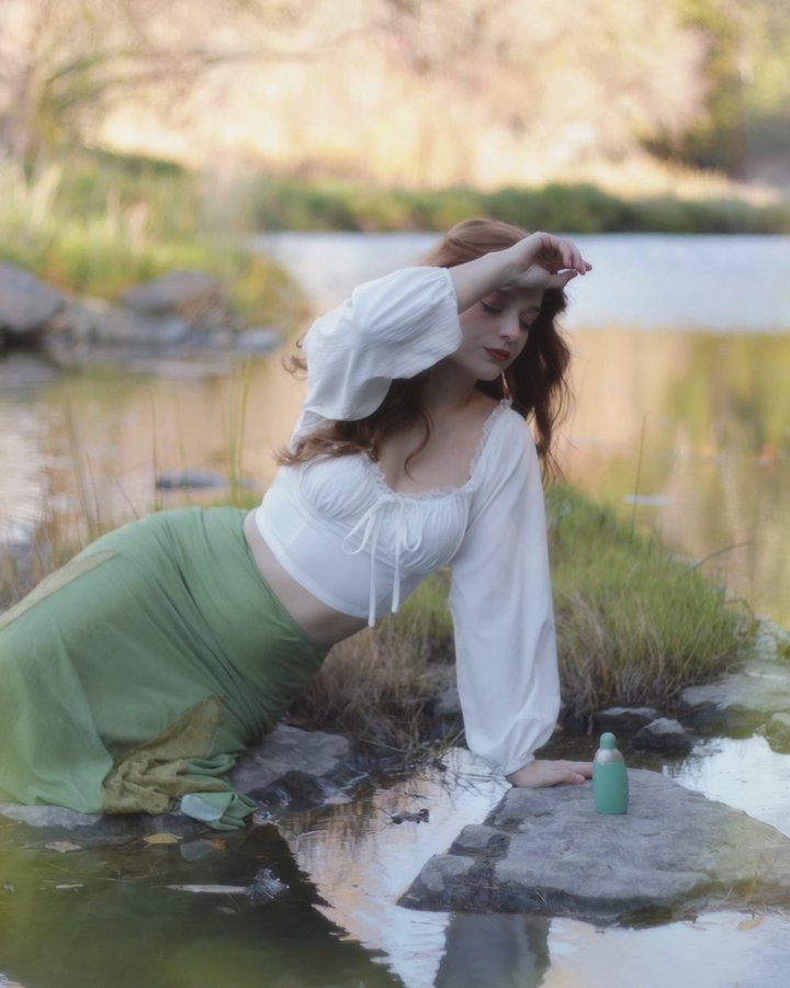 Instagram post by @romyvictory for Cacharel Parfums. Caption reads: Looking for myself in the water’s reflection 🪞🪷.