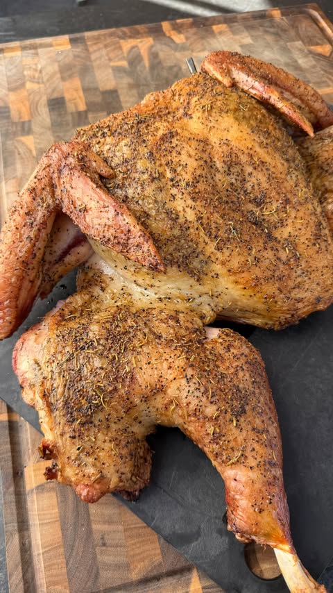 Instagram post by @cooking_with_fire___ for Pit Boss Grills. Caption reads: Garlic Butter Truffle Smoked Spatchcock Turkey on....