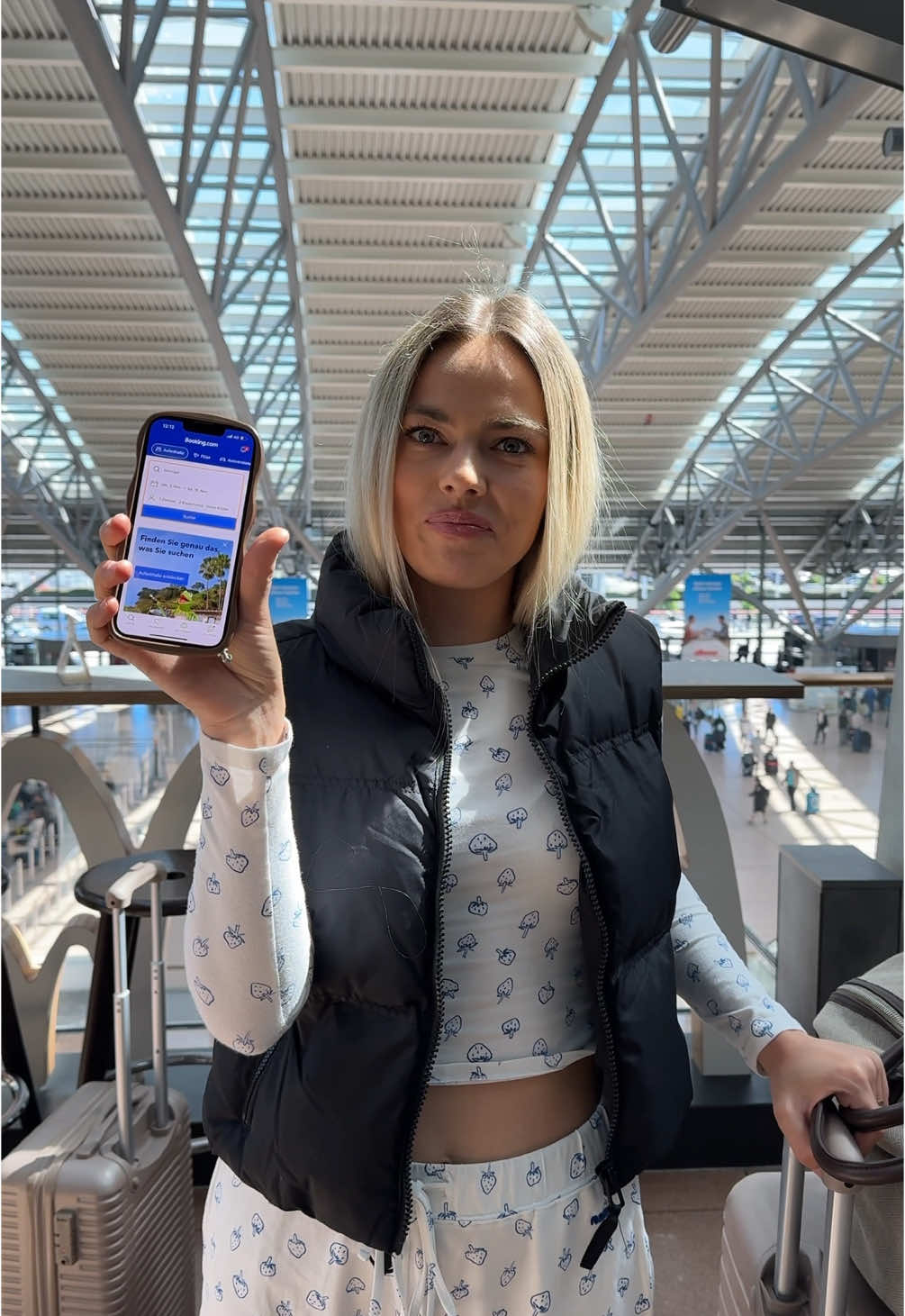 TikTok post by @iam.stassy for Booking.com. Caption reads: Er weiß nicht mal wo wir hin fliegen 🥲🤣....