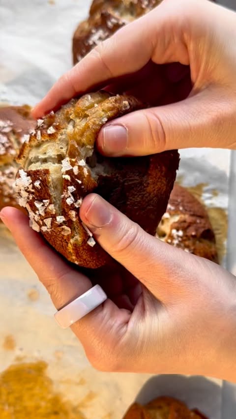 Instagram post by @theglutenlessmaximus for King Arthur Baking Company. Caption reads: 🍞 These gluten-free pretzel buns are soft, chewy,....