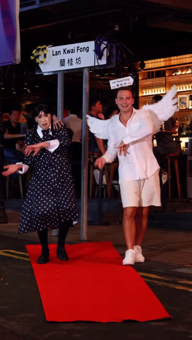 Instagram post by @andrejko.epta for Discover Hong Kong. Caption reads: If darkness had style, it’d be Wednesday🕷️👑....