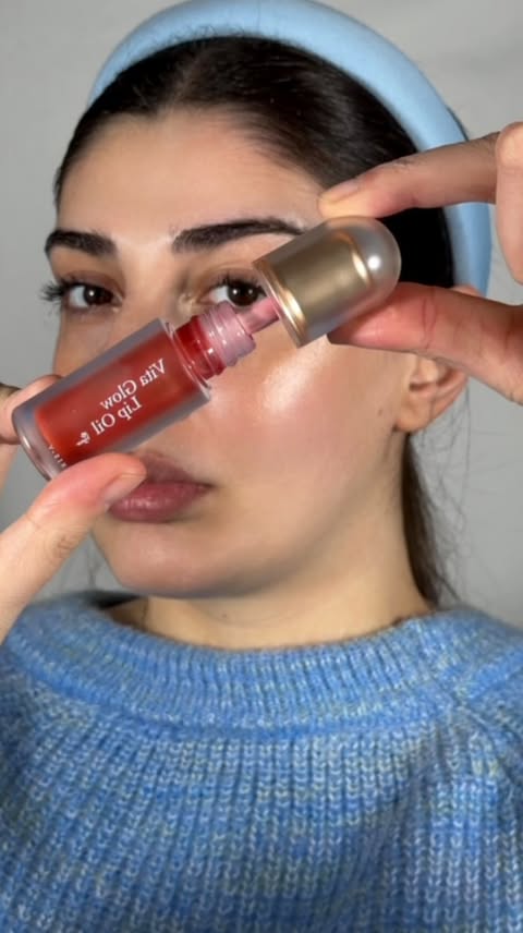 Instagram post by @aniichakhunashvili for Axis-y. Caption reads: Meet the new @axisy_official AXIS-Y lip oils....