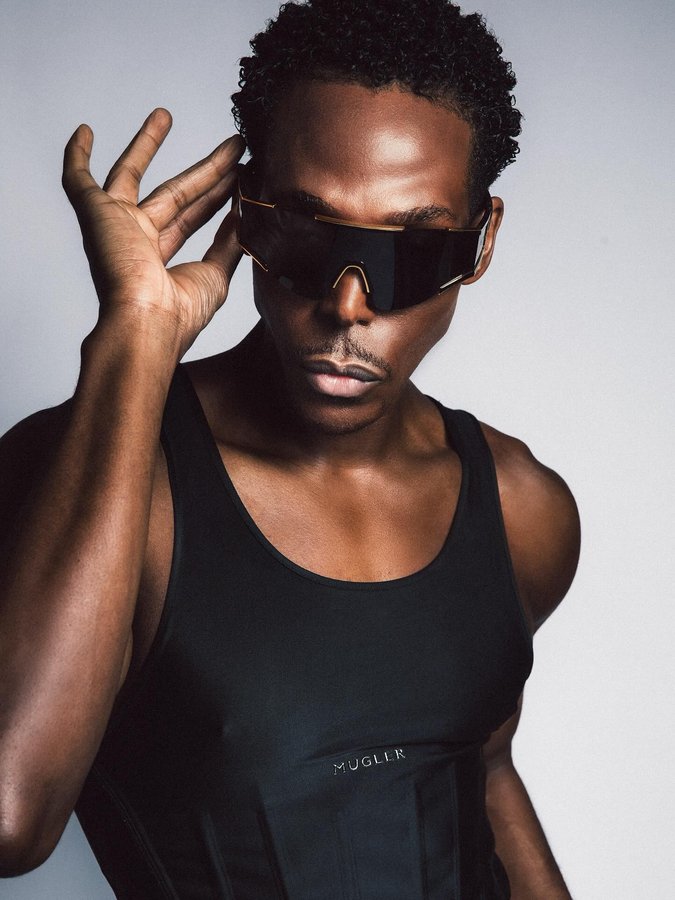 Instagram post by @joshuduma for Mugler. Caption reads: i spy, w/ my little eye... 🥷🏾- @muglerofficial....