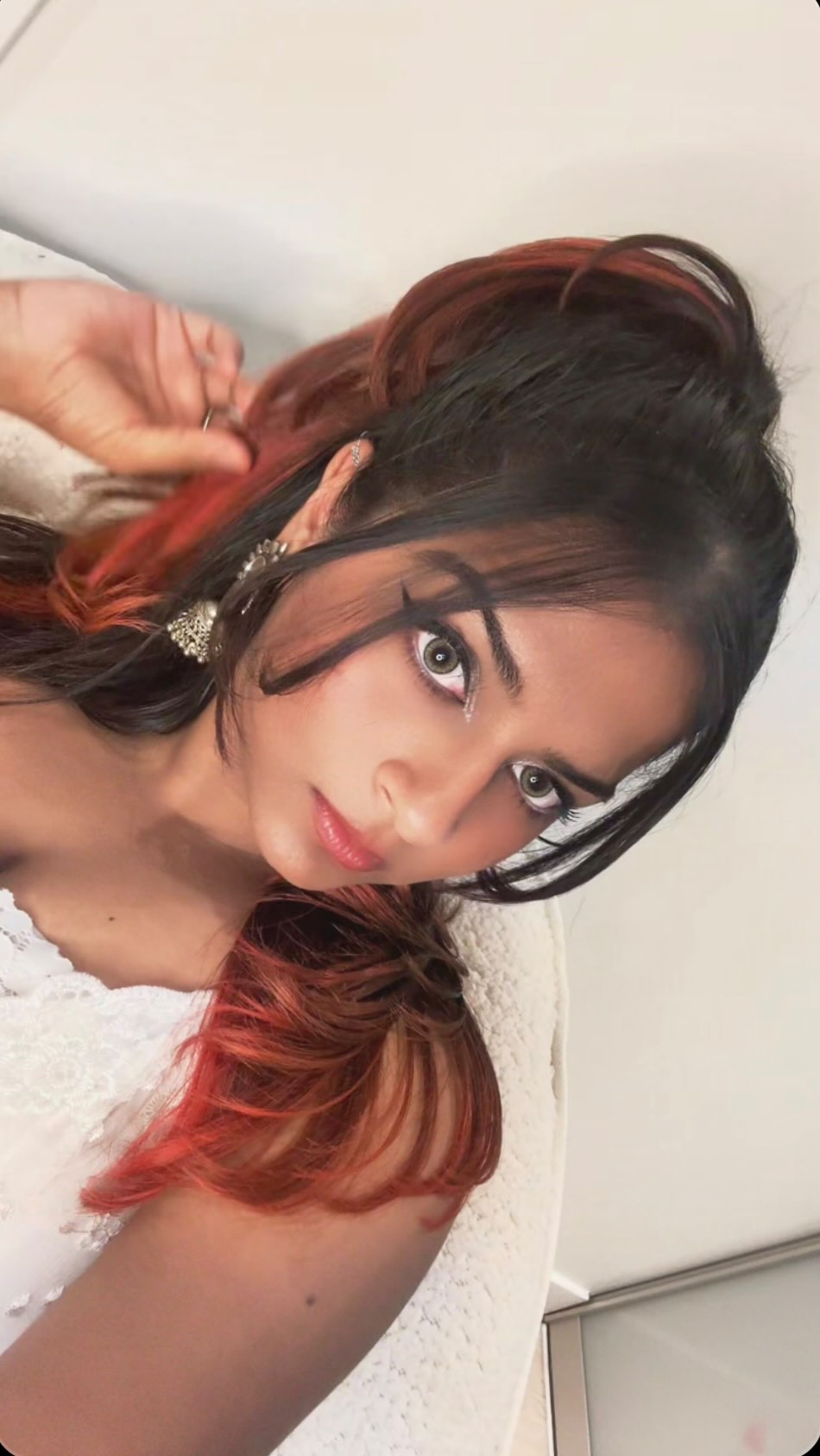 Instagram post by @tripti.prajapatii for Urban Decay. Caption reads: 🦢🤍✨

Lens shade: Pro Hazel....