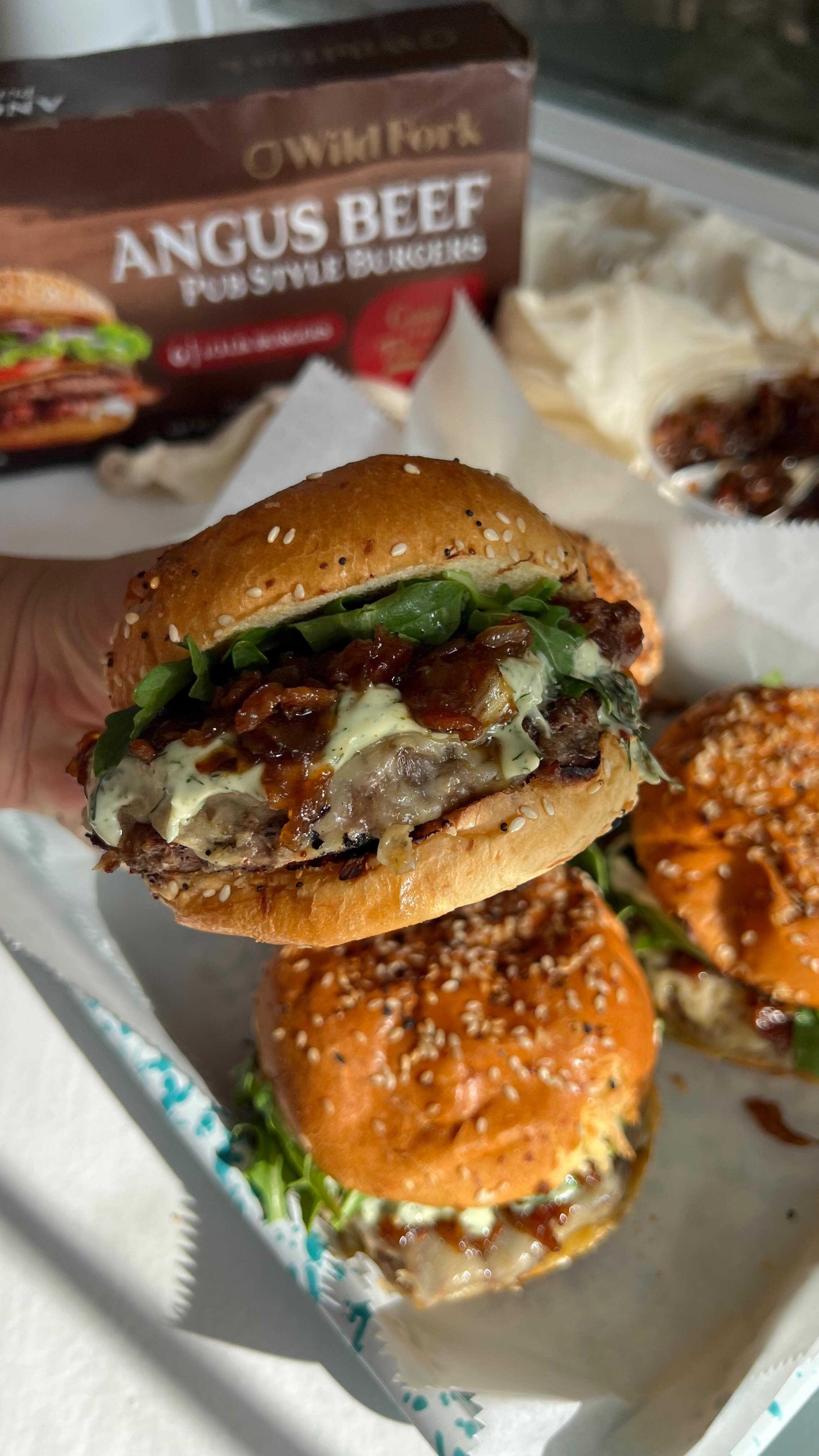 Instagram post by @broccyourbody for Wild Fork Foods. Caption reads: #ad There’s nothing better than a juicy burger hot....