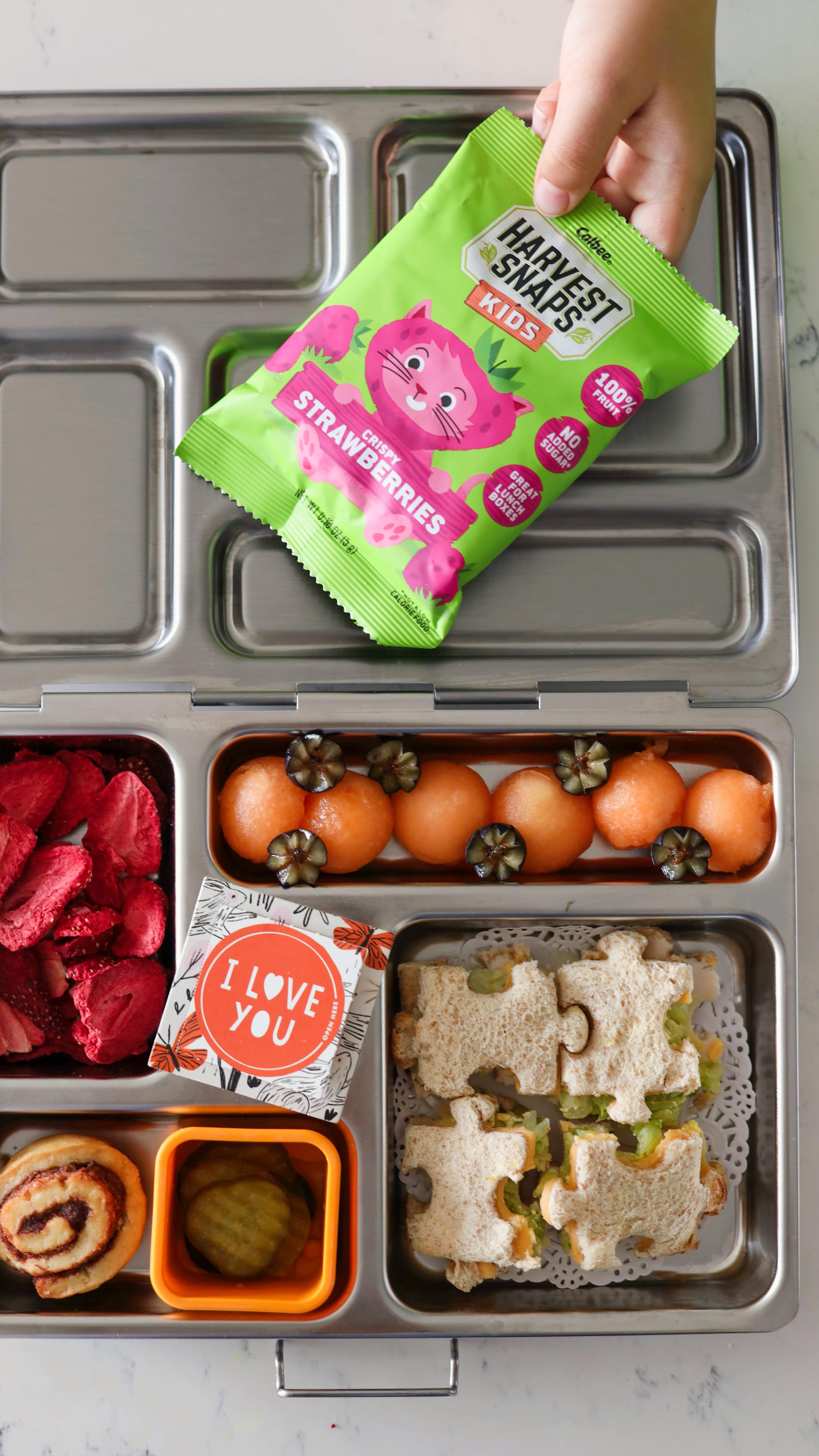 Instagram post by @food.kids.love for Harvest Snaps. Caption reads: Stocking up on all four flavors of @harvestsnaps....