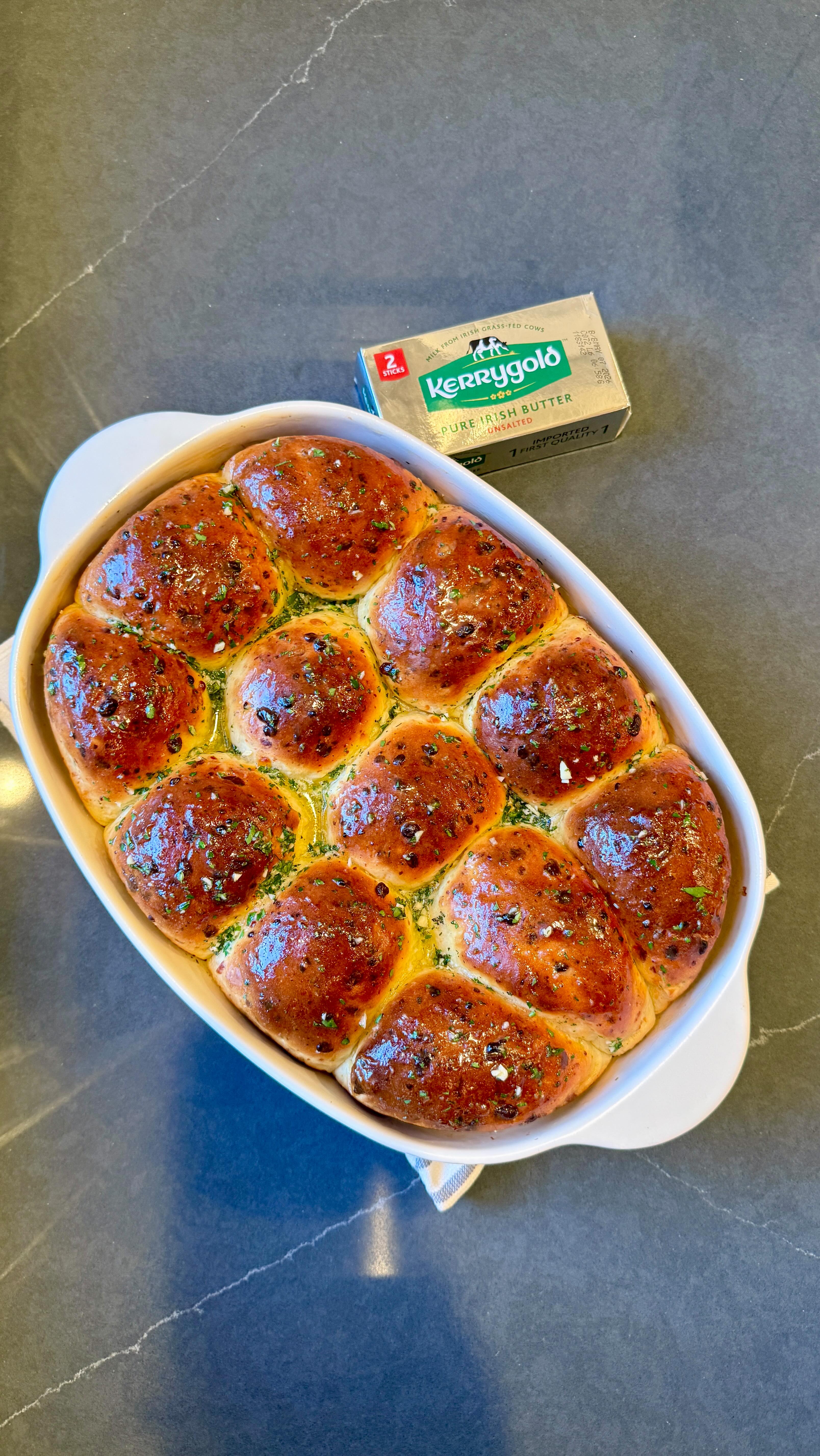 Instagram post by @emmanuel.duverneau for KerrygoldUSA. Caption reads: #ad These Cheesy Garlic Butter Rolls were made....