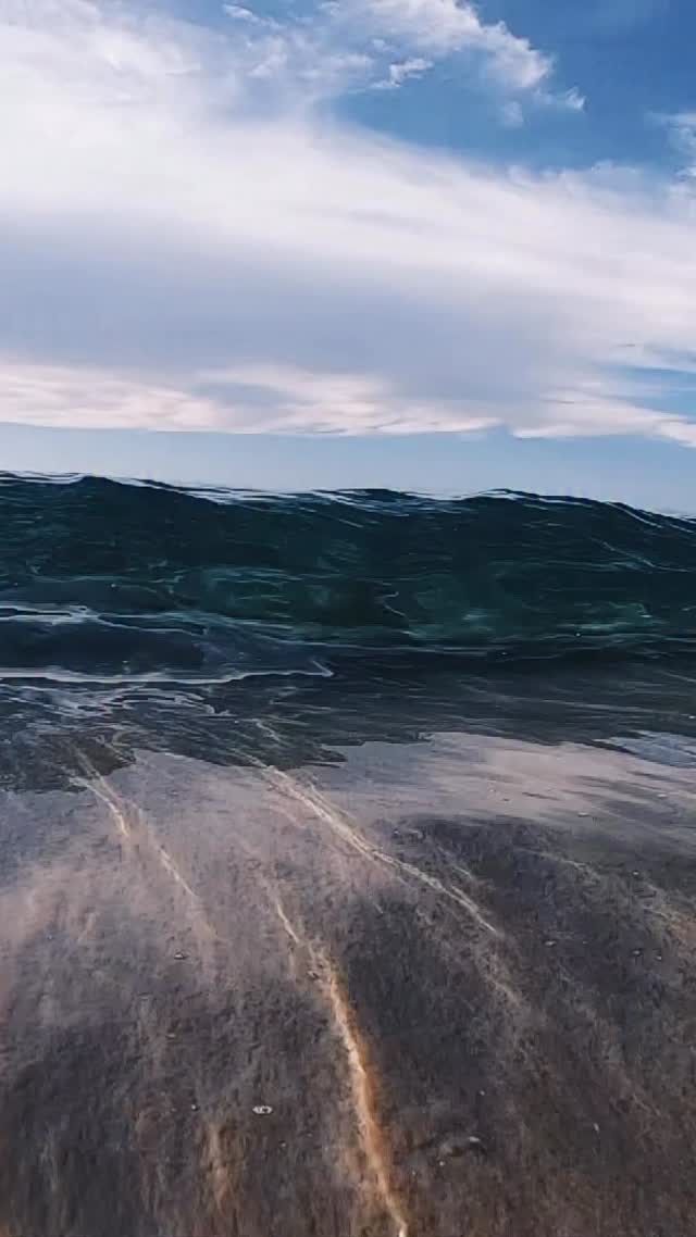 Instagram post by @nolanomura for GoPro. Caption reads: Looking through a wave 🌊 @gopro #gopro.