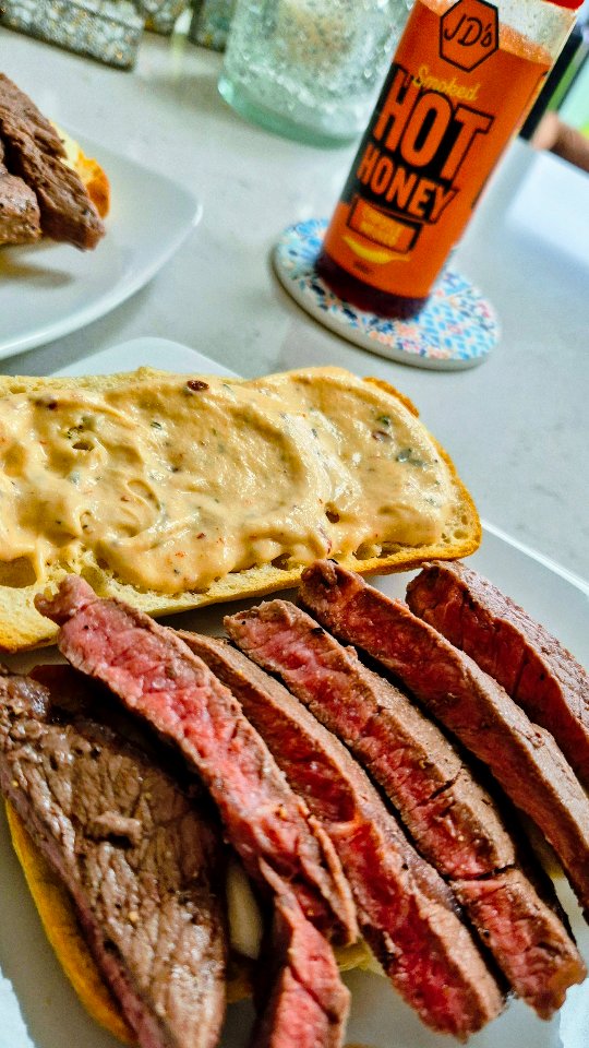 Instagram post by @scrimpy_scottie for JD’s Hot Honey. Caption reads: 🍯 Honey Ranch Steak Sandwich 🍯
Ad|Gifted....