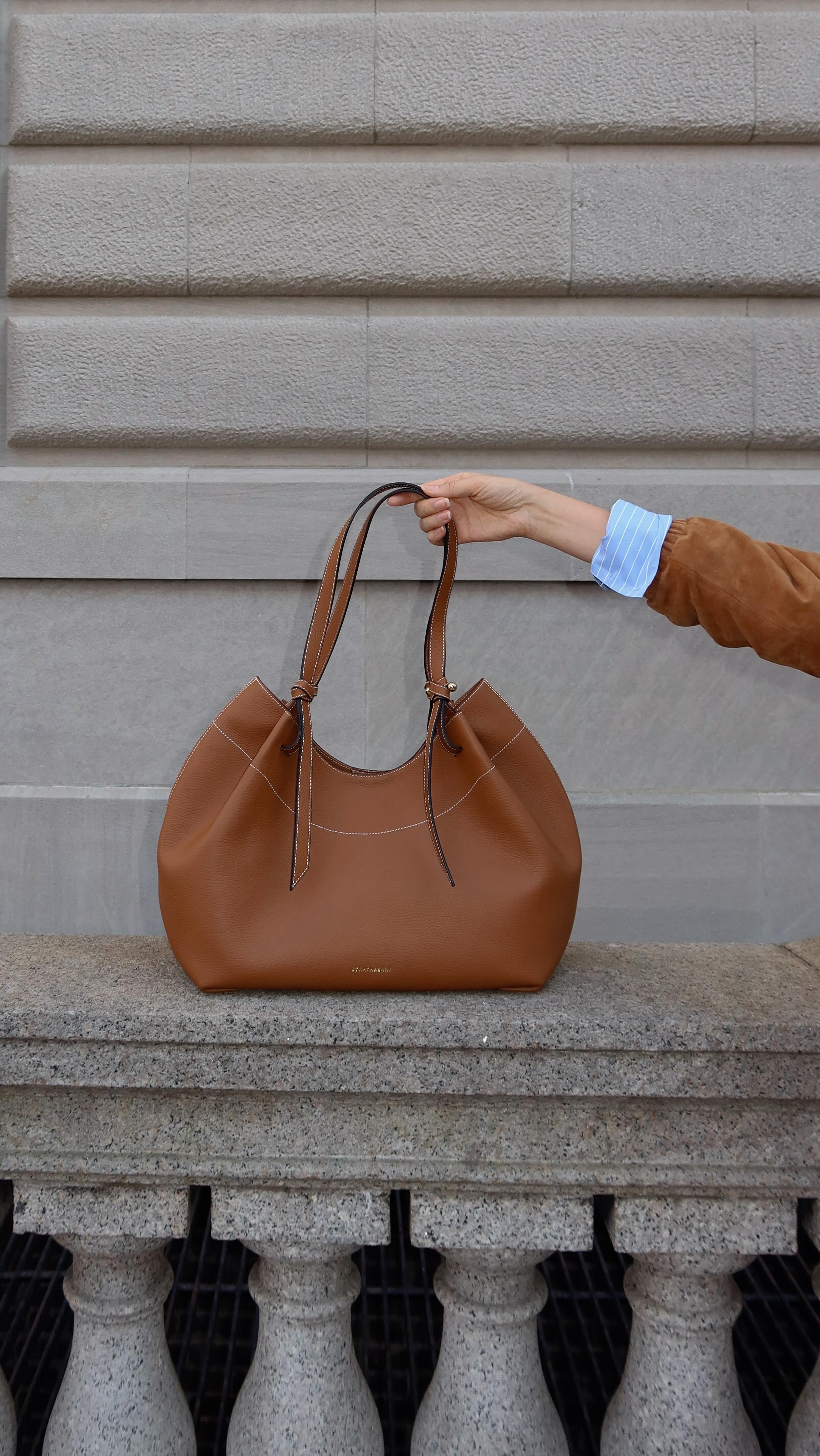 Instagram post by @karinabnyc for Strathberry. Caption reads: Meet this new beauty from @strathberry - The Barra....