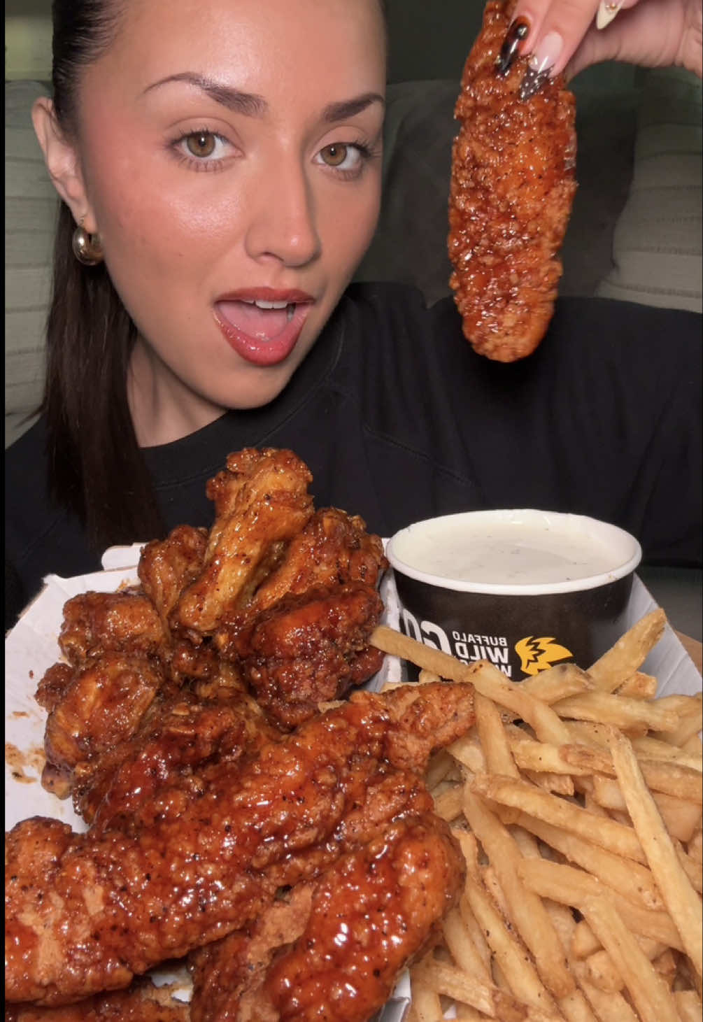 TikTok post by @cabreranali for Buffalo Wild Wings. Caption reads: trying @Buffalo Wild Wings NEW brown sugar heat....