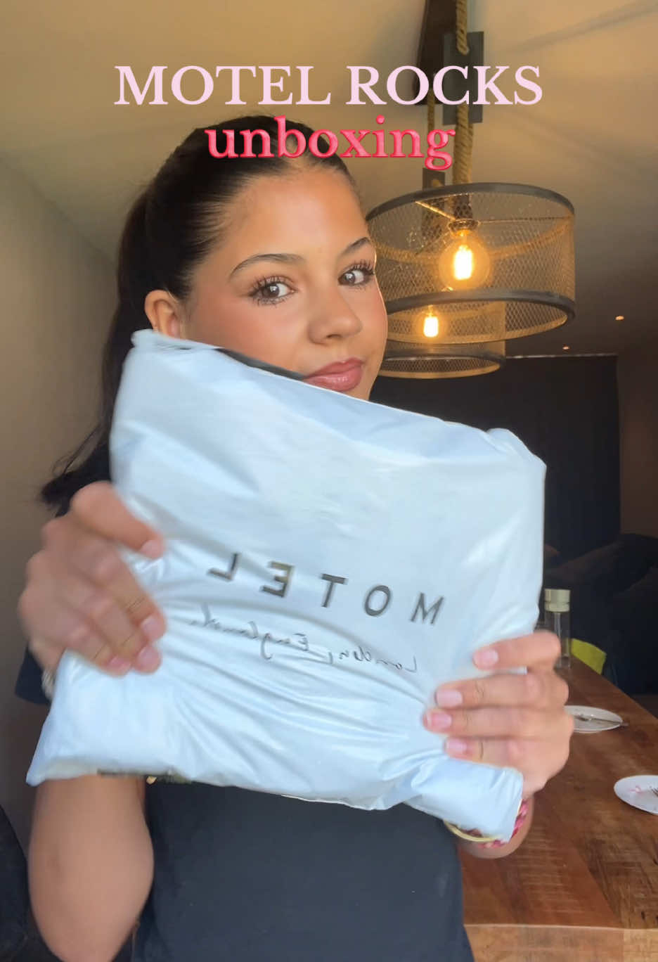 TikTok post by @noraegrwm for MOTEL. Caption reads: unboxing van @MOTEL 💋 #motelrocks #unboxing....
