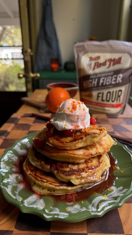 Instagram post by @sokos.kitchen for Bob's Red Mill. Caption reads: CRANBERRY ORANGE PANCAKES 🍊🥞 my new favorite....