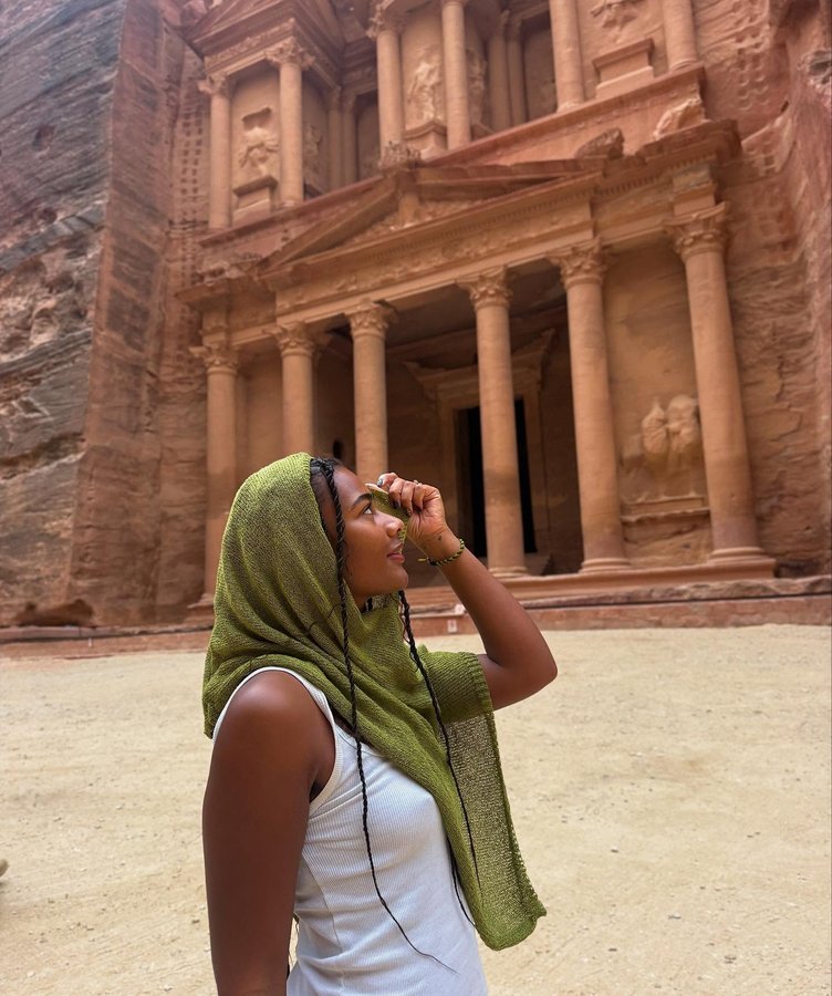 Instagram post by @dominiquetravelsss for G Adventures. Caption reads: My 5th wonder of the world | Petra, Jordan🇯🇴 5/7....