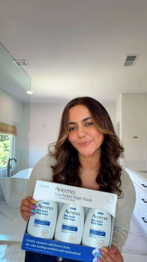 Instagram post by @beautyy.by.kay for IPC Creators. Caption reads: #AD Hello soft skin👋🏽✨🫧 🌊Save $3 on Aveeno®....