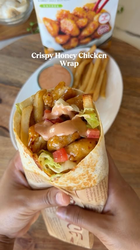 Instagram post by @platedbyyuri for InnovAsian Cuisine. Caption reads: Crispy Honey Chicken Wrap 🌯🍯 #InnovAsianPartner....