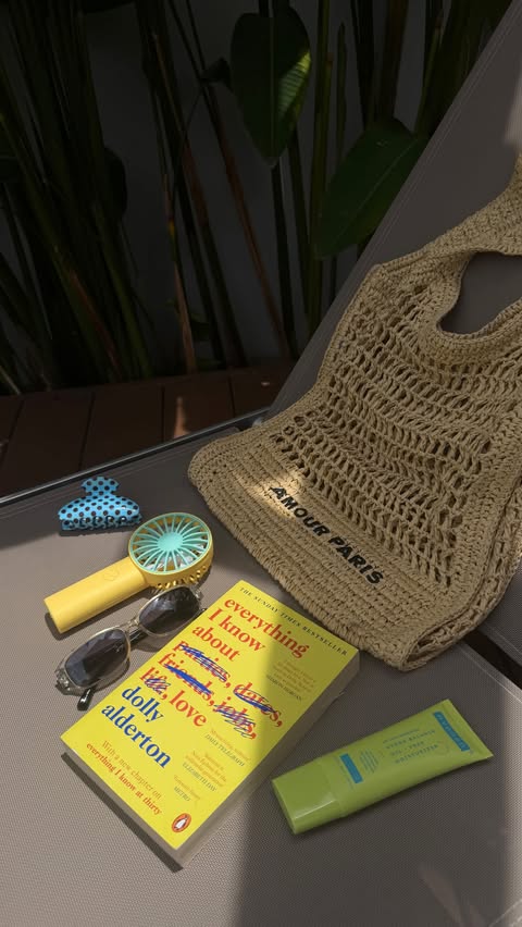 Instagram post by @anushkahazraa for Hyphen. Caption reads: a realistic what’s in my beach bag 🌊☀️ comment....