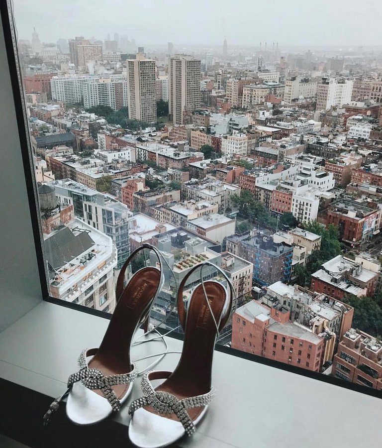 Instagram post by @kristinanovaofficial for AQUAZZURA. Caption reads: Too cold to wear them but so 😍 @aquazzura #ad.