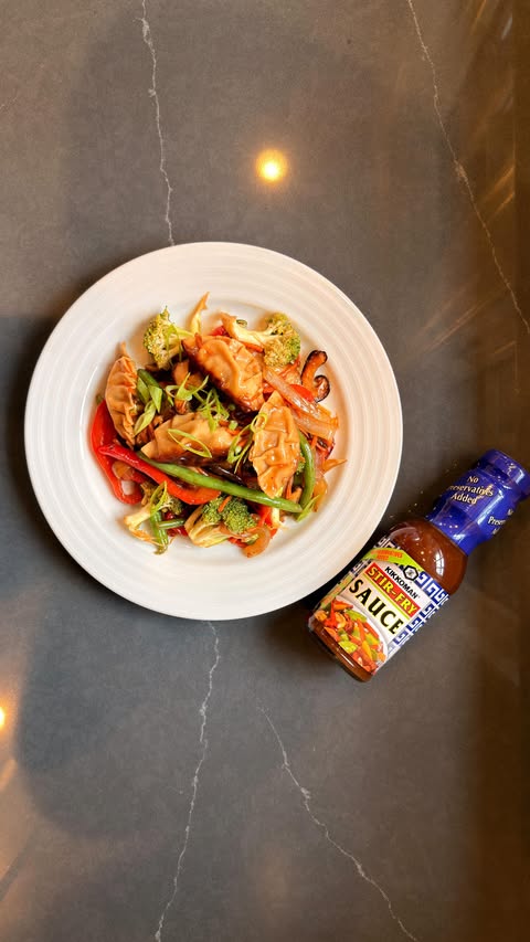 Instagram post by @emmanuel.duverneau for Kikkoman USA. Caption reads: This take-out-worthy gyoza stir-fry was made quick....