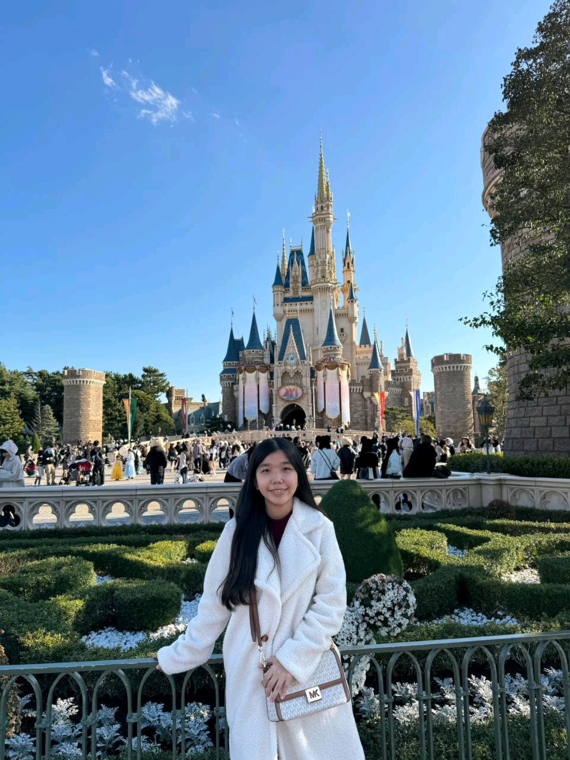 TikTok post by @faecelinee for agoda. Caption reads: Just pure happiness at the happiest place on earth....