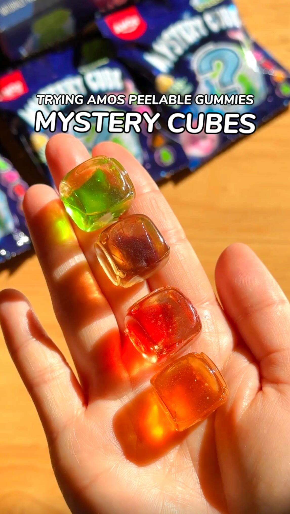 Instagram post by @eatsbyrachel for Amos Sweets. Caption reads: [...] mystery cubes ✨ have arrived! @amossweets....