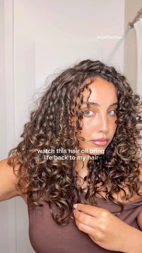 Instagram post by @tondreannaesquilin for IGK Hair. Caption reads: [...] of using a dry hair oil until I saw @IGKHair....