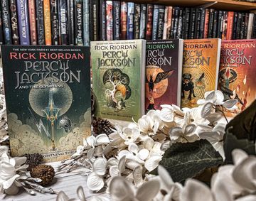 Instagram post by @caitsbooks for Read Riordan. Caption reads: [ad @readriordan] What’s a book/series cover....