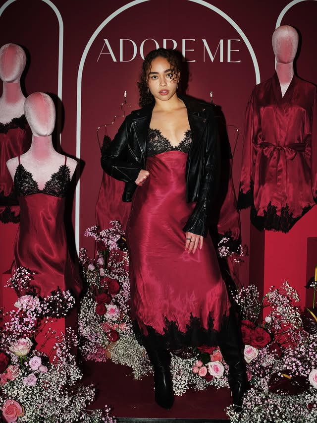 Instagram post by @baileybass for Adore Me. Caption reads: [...] have in common? Red is their color. 🤭....