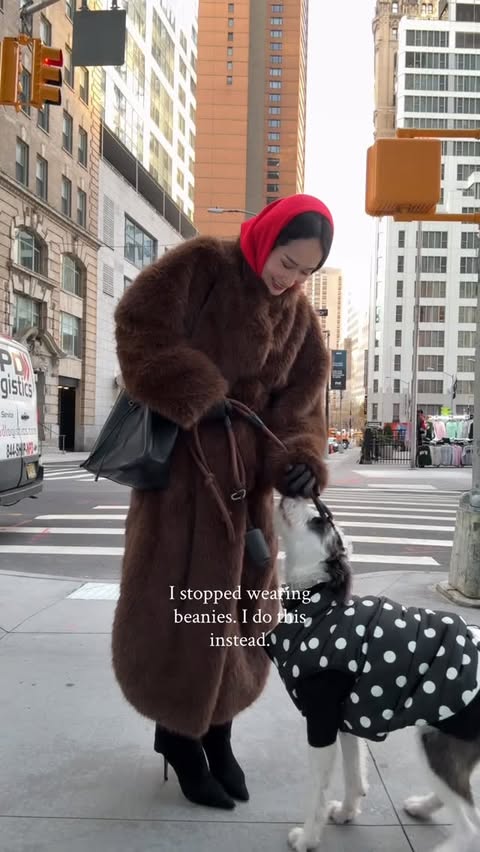 Instagram post by @isabeltan for STUART WEITZMAN. Caption reads: Scarf hood > beanies. How I Dress Chic When It’s....